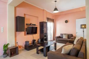 a living room with a couch and a table at Agios Pavlos Corner Vacation House Zakinthos in Zakynthos Town