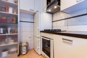 a kitchen with a stove and a refrigerator at Apartment Anna in Zadar