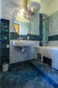 a bathroom with a sink and a mirror and a tub at Apartment Anna in Zadar +27 photos