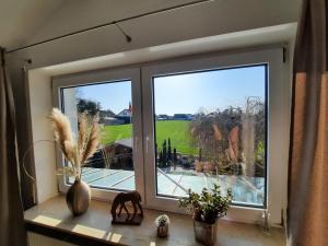 a window with a view of a golf course at Pflaumers Ferienwohnung in Eppingen