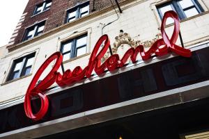 a red neon sign on the side of a building at Freehand Chicago in Chicago