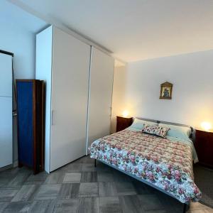 a bedroom with a bed and a large closet at Casali appartamento in San Marino
