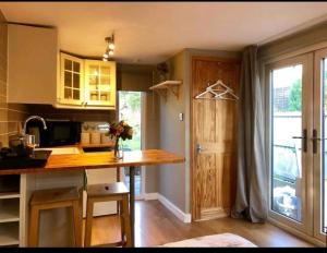 a kitchen with a wooden counter top in a room at Unique wooden lodge with a view! in London