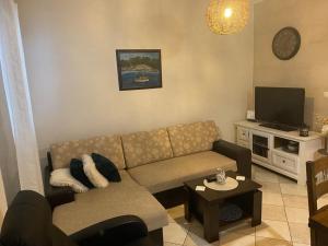 a living room with a couch and a tv at Pipe in Metajna