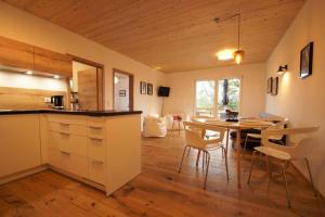 a kitchen and dining room with a table and chairs at Linda‘s Ferien-Pferdehof in Sigmarszell