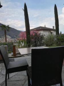 a couple of chairs sitting on a patio at Cascina nel Bosco in Cannobio