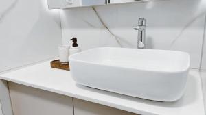 a white bathroom sink on a white counter at Apartment in central Dubrovnik with private parking in Dubrovnik