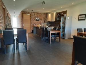 a kitchen and dining room with a table and chairs at Jaegershoes in Belfeld +5 photos