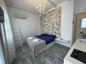 a bedroom with a blue bed and a sink at BURGOS BARRIO in Naxos Chora