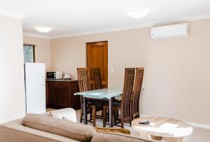 a living room with a table and a couch at Edenbrook Country Manor in Plettenberg Bay