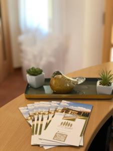 a wooden table with a tray with a magazine on it at Hotel Garni Klaret in Valtice