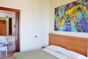 Postel nebo postele na pokoji v ubytování Hotel Cristina