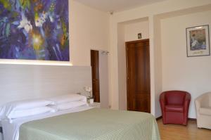 Postel nebo postele na pokoji v ubytování Hotel Cristina