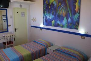 Postel nebo postele na pokoji v ubytování Hotel Cristina