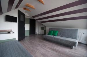 a living room with a couch and a striped ceiling at Noclegi Pobierowo NATALIA - przy morzu in Pobierowo