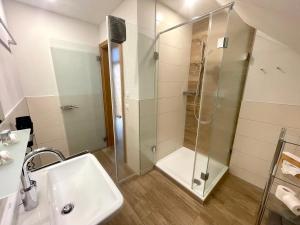 a bathroom with a shower and a sink at Landgasthof Linde Hepbach, Hotel & Restaurant in Markdorf