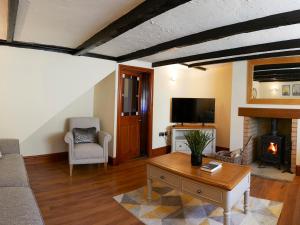 a living room with a couch and a fireplace at Courtyard Cottage in Filey