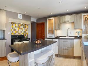 a kitchen with a large island with a counter top at Courtyard Cottage in Filey
