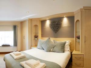 a bedroom with a large bed with a heart on the wall at Courtyard Cottage in Filey