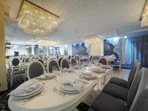 a dining room with a long table and chairs at Hotel Anastasia in Sibiu