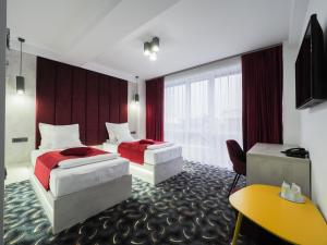 Säng eller sängar i ett rum på Hotel Anastasia