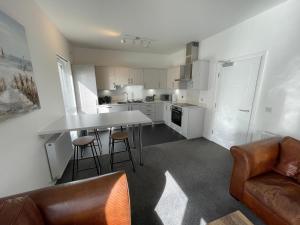 a kitchen with a couch and a table and chairs at Atholl Place View in Inverness