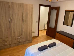 - une chambre avec un lit et 2 serviettes noires dans l'établissement Apartamento low cost, à Gijón 2 autres photos