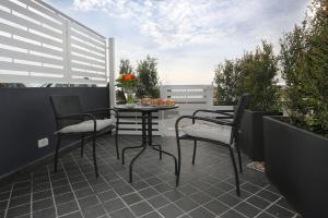 a patio with chairs and a table on a balcony at AG Luxury Rooms in Giardini Naxos