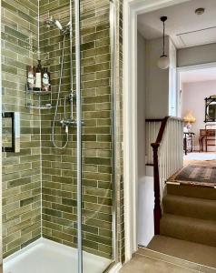 uma casa de banho com um chuveiro e uma porta de vidro em Gloucester House em Hastings