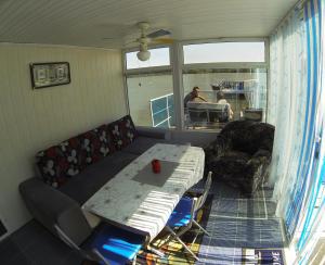 a living room with a couch and a table at Delta Pontoon in Mahmudia