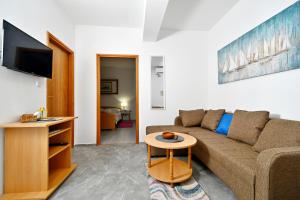 a living room with a couch and a table at apartmani Novotny- žuti in Rab