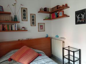 a bedroom with a bed and bookshelves on the wall at CASA VACANZE "A casa di Maria" in Naples