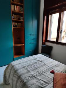 a bedroom with a bed and a book shelf at CASA VACANZE "A casa di Maria" in Naples