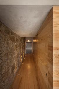 an empty room with a wooden floor and wooden walls at FLORES 36 by YoursPorto in Porto