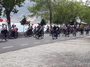 a large group of people riding bikes down a street at Choo Choo Pansiyon in Egirdir