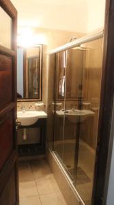 un bagno con due lavandini e una doccia in vetro di Tradición de Salta a Salta