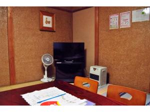 a room with a table with a fan and a desk with chairs at Guest House HiDE - Vacation STAY 64833v in Lake Toya