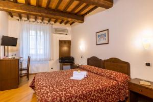 Postel nebo postele na pokoji v ubytování Hotel La Pace