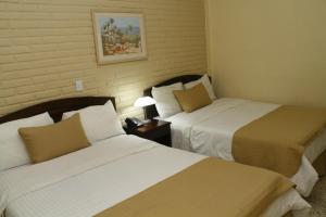 Cama o camas de una habitación en Hotel Mac Arthur