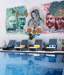 a mural on a wall next to a swimming pool at Castillo De La Santa Cruz in Guanajuato