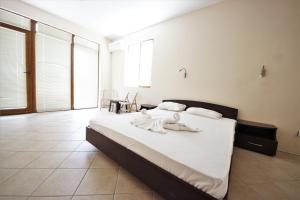 a bedroom with a large white bed with white sheets at Menada Midia Apartments in Sunny Beach