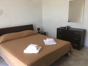 Ένα ή περισσότερα κρεβάτια σε δωμάτιο στο Residence S’Oggiastrone