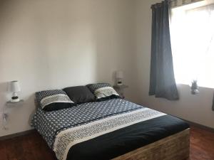 a bedroom with a large bed with a window at Logement détente avec jacuzzi et billard américain in Fournols