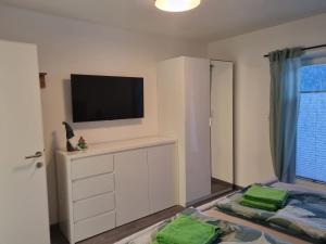 a living room with a tv and a dresser with a flat screen at Haus Schönblick in Neustift im Stubaital