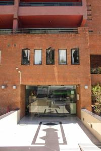 a large brick building with a patio in front of it at Departamento mall costanera in Santiago