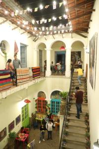 a group of people walking down a staircase in a building at Hostel Cultural Pata y Perro in Tarija