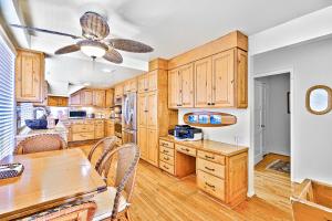 a kitchen with wooden cabinets and a table with chairs at Laguna Beach Oceanfront in Laguna Beach