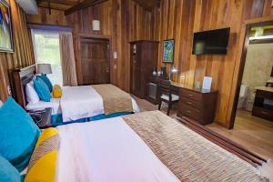Cama o camas de una habitación en Hotel Lomas del Volcan