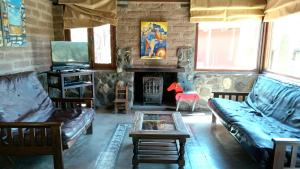 a living room with a couch and a fireplace at Miraluna Bodega Boutique in Cachí