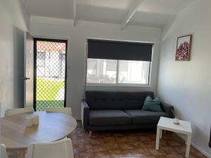 a living room with a couch and a table at Robe Nampara Cottages in Robe